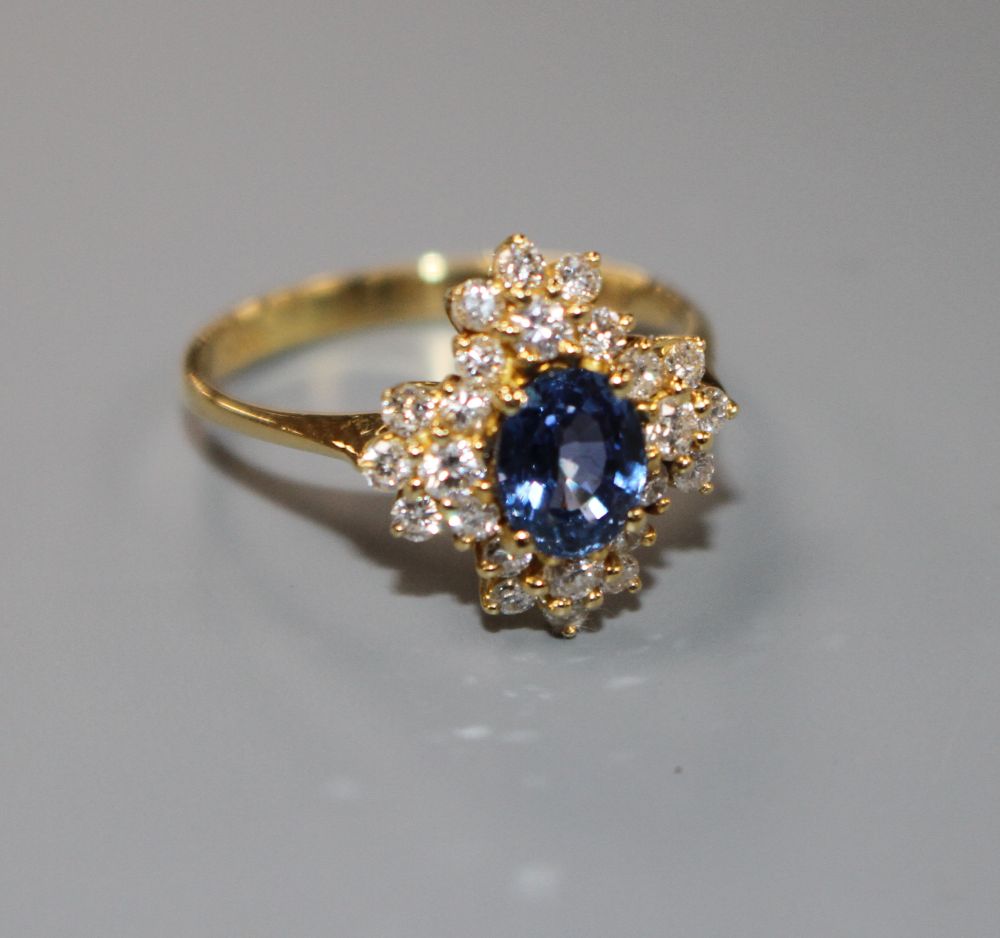 A modern 18ct gold, sapphire and diamonds set quatrefoil shaped cluster ring, size M, gross 4 grams